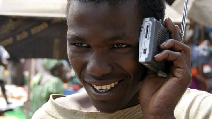 Photo: a man listening to a radio. Credit: BBC Pidgin